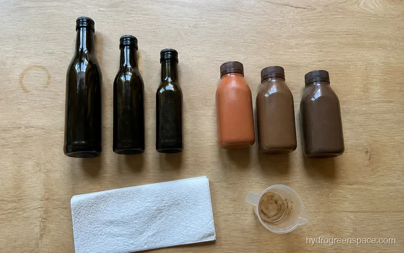 Two sets of three hydroponic nutrient bottles arranged side by side on a wooden table in natural light
